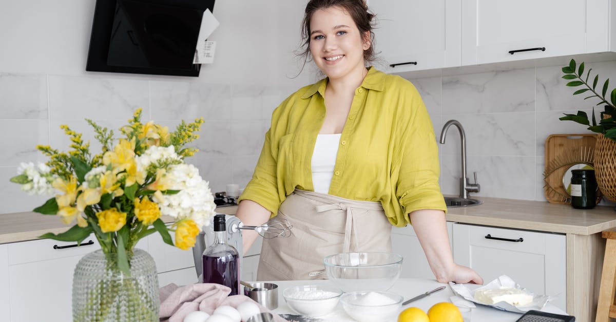 Sous vide egg white falling apart on cracking - Smiling housewife with ingredients on table