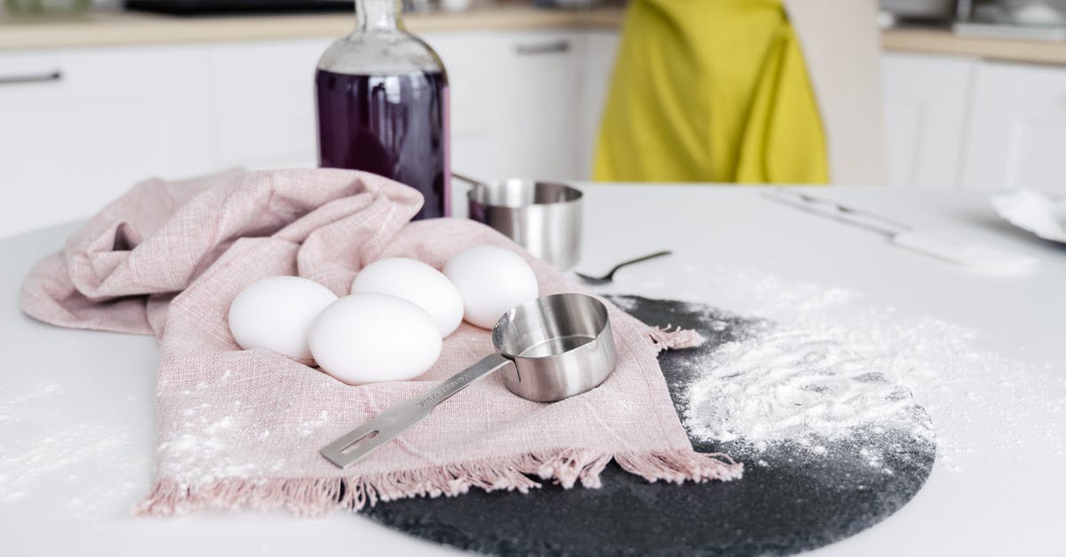 Sous vide egg white falling apart on cracking - Crop woman near table with eggs