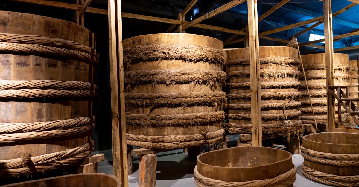 Soy Sauce storage container - Fish sauce fermenting in wooden large barrels placed in row in local manufacture factory