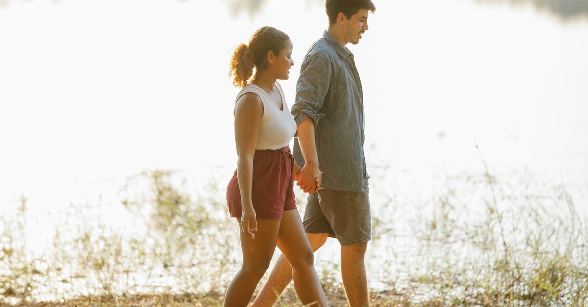 Spice Mixture for a Hiking Trip [closed] - Loving young multiethnic couple holding hands while hiking on lake shore