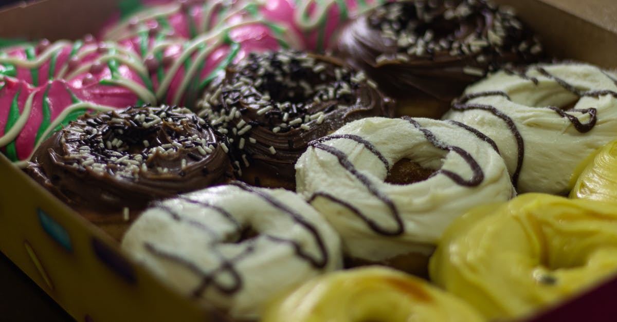 Sprinkle colors that bleed into icing - A Box of Donuts in Different Flavors