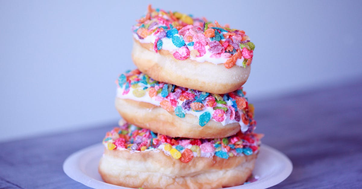 Sprinkles on rolled icing - Close-up Photo of Stacked of Doughnuts