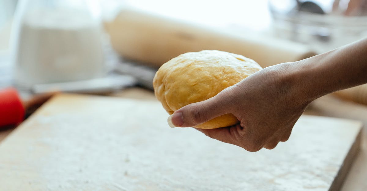 Squashing cookie balls vs slicing them - Female hand with row dough