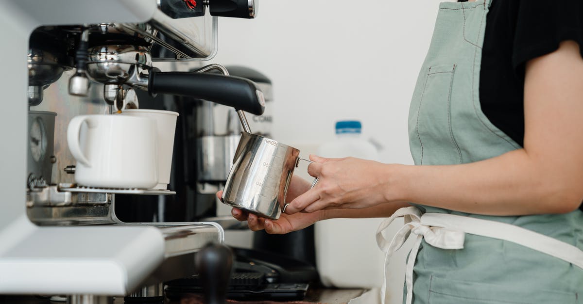 Steam "nature" of cappuccino steamers - Crop young barista preparing fresh latte in cafe