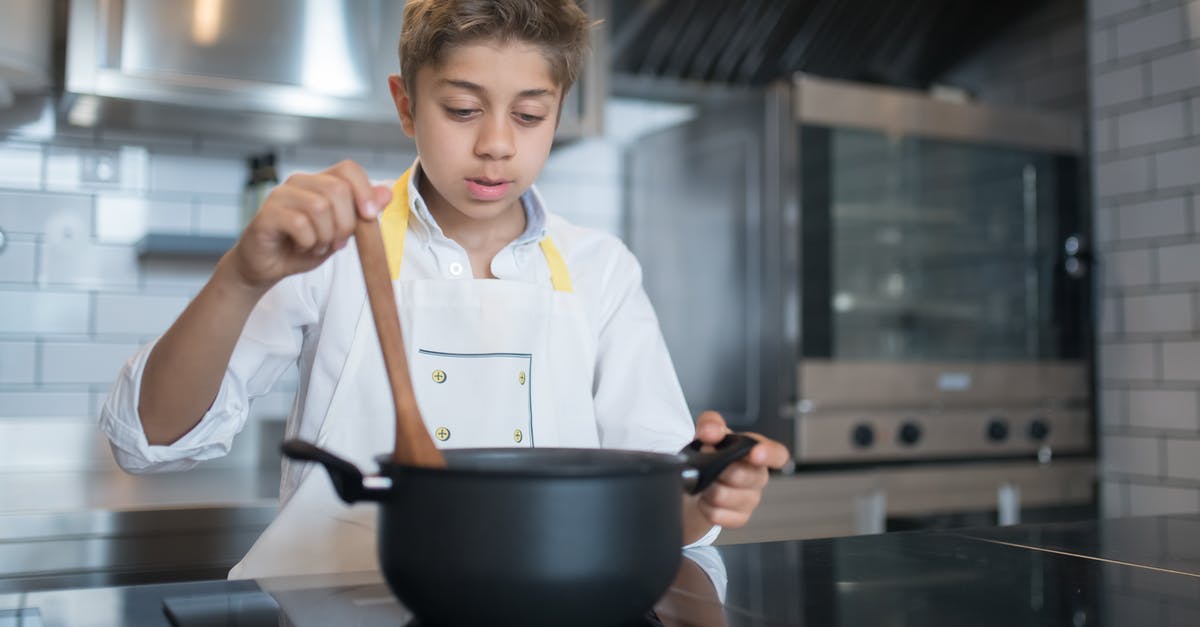 Stirring butter toffee mixture while cooking - A Young Boy Stirring a Pot
