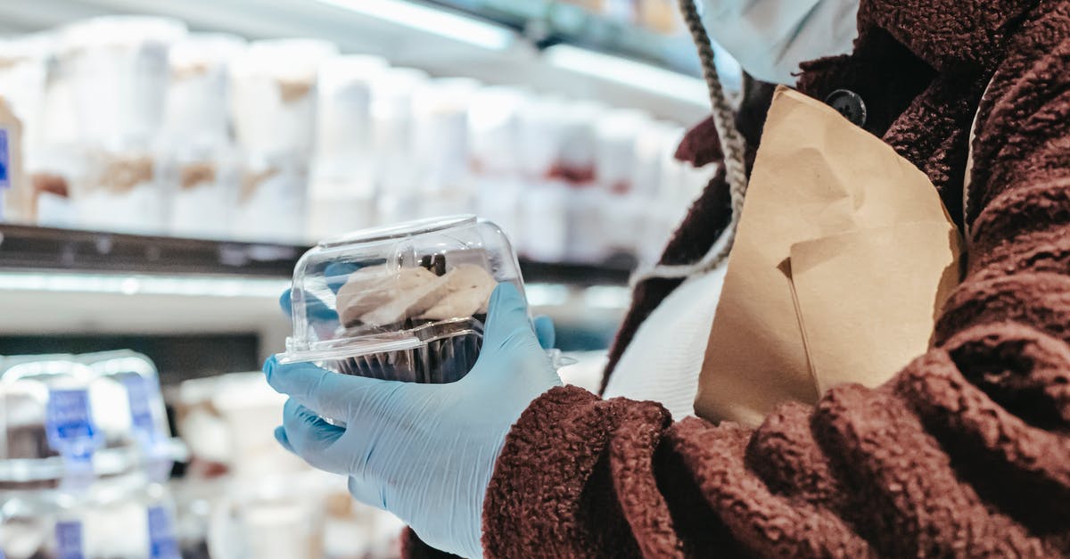 Storing cake batter - Anonymous black female in mask and gloves shopping in supermarket