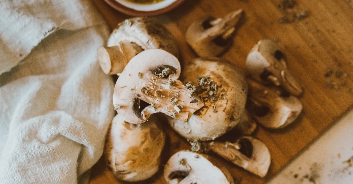 Storing cut button mushrooms vs whole button mushrooms - Brown and White Mushrooms on Brown Wooden Table