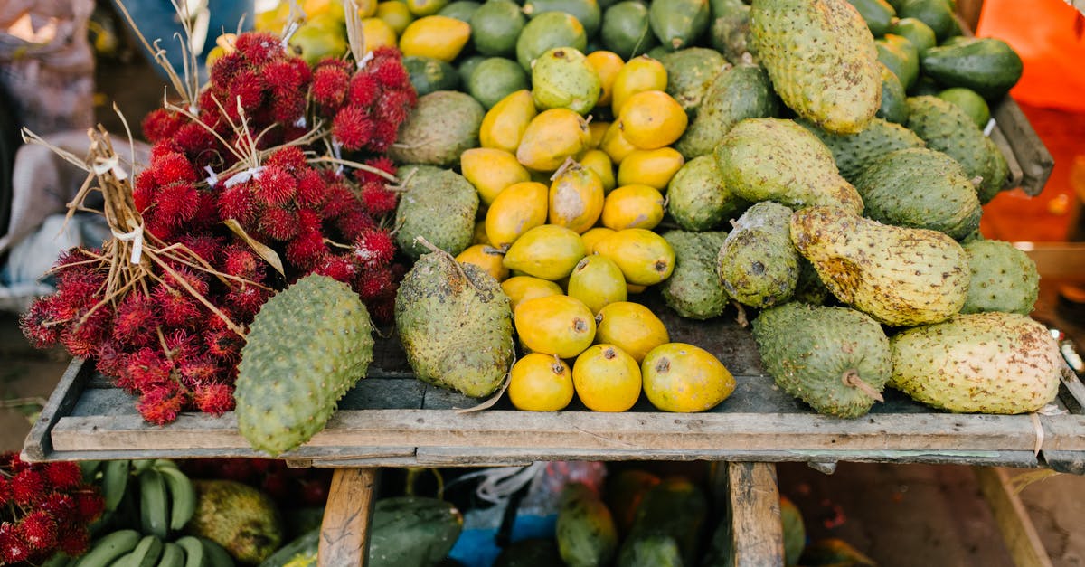 Storing raw cranberry - Assorted tropical fruits on stall at market