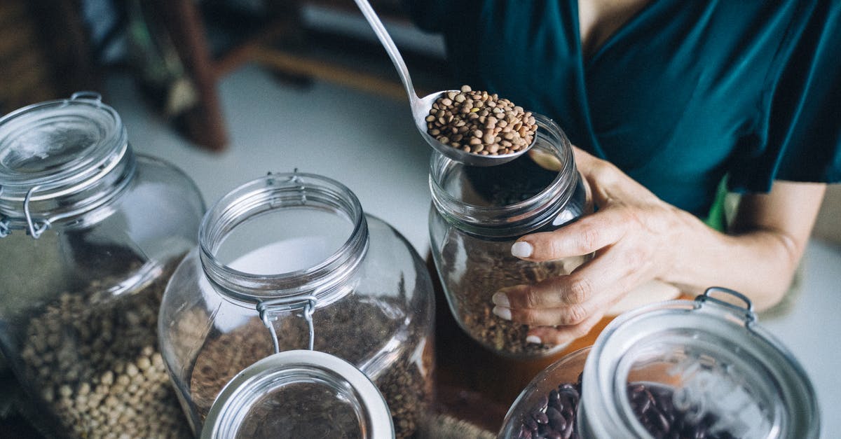 Storing rehydrated beans [duplicate] - A Person Refilling Beans on a Glass Jar