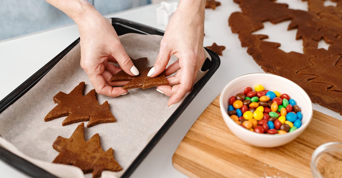 Storing Self-Made Cookies/Brittles/etc longer: ingredients and techniques - Person Putting Christmas Tree Shaped Cookies on a Tray