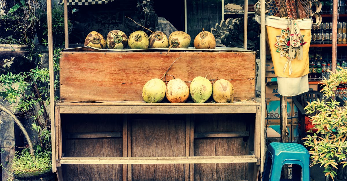 Storing/transporting nut brittle in tins - Photo of Store Selling Coconuts