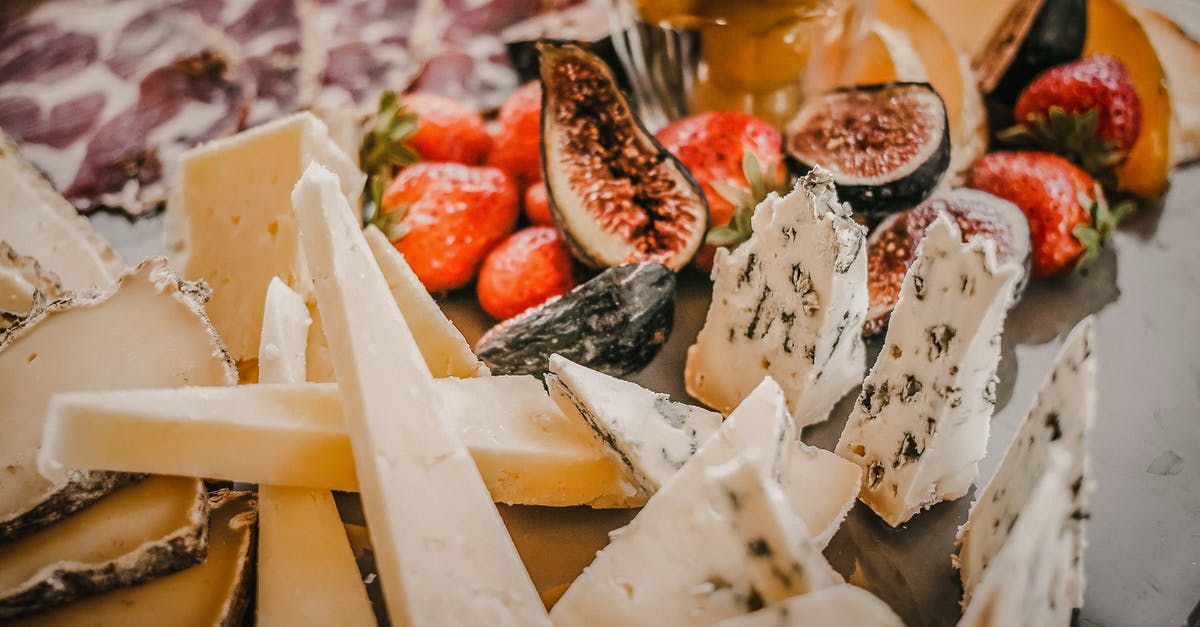 strawberry and fig vincotto - Various types of cheese near fruits and berries