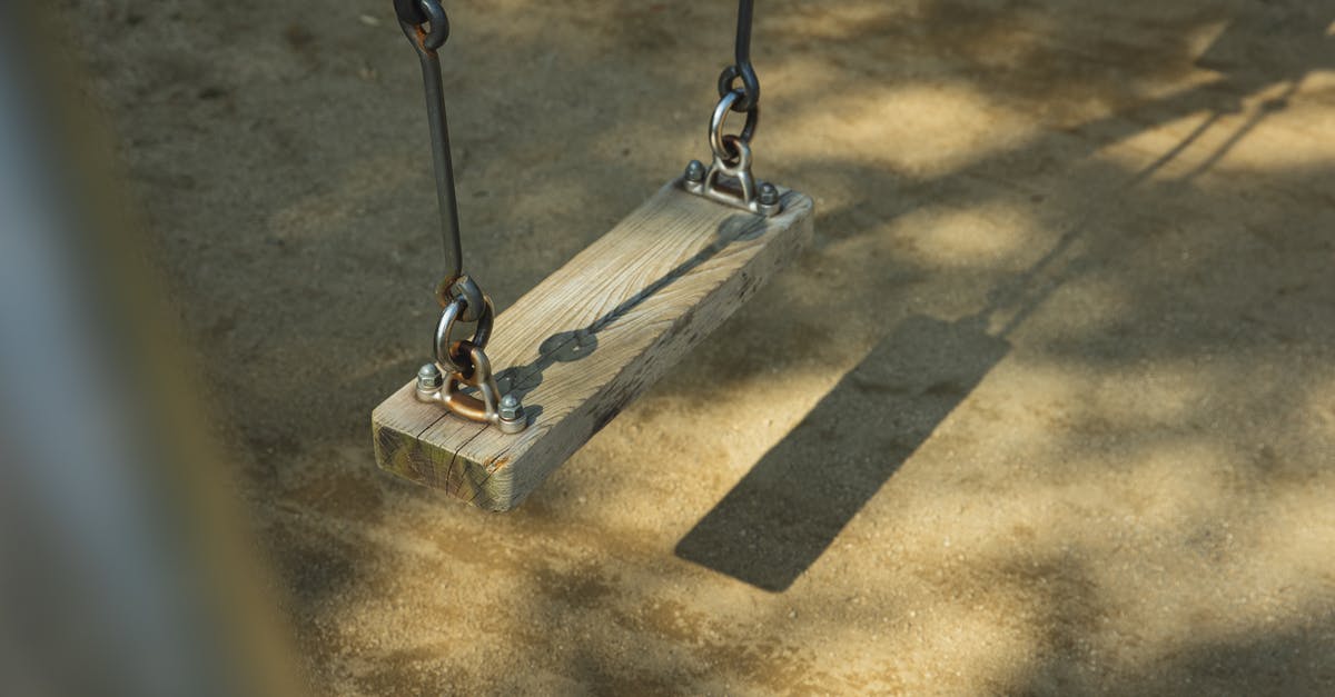 Stripping seasoning from cast iron - Metal and wooden swing in park