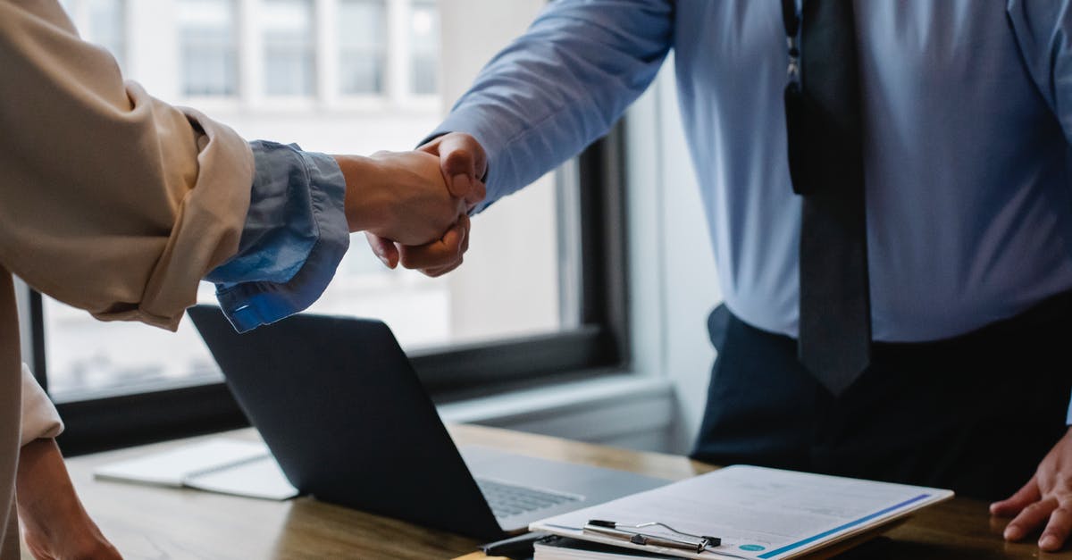 Stronger bread, how could I achieve that? - Crop unrecognizable coworkers in formal wear standing at table with laptop and documents while greeting each other before meeting