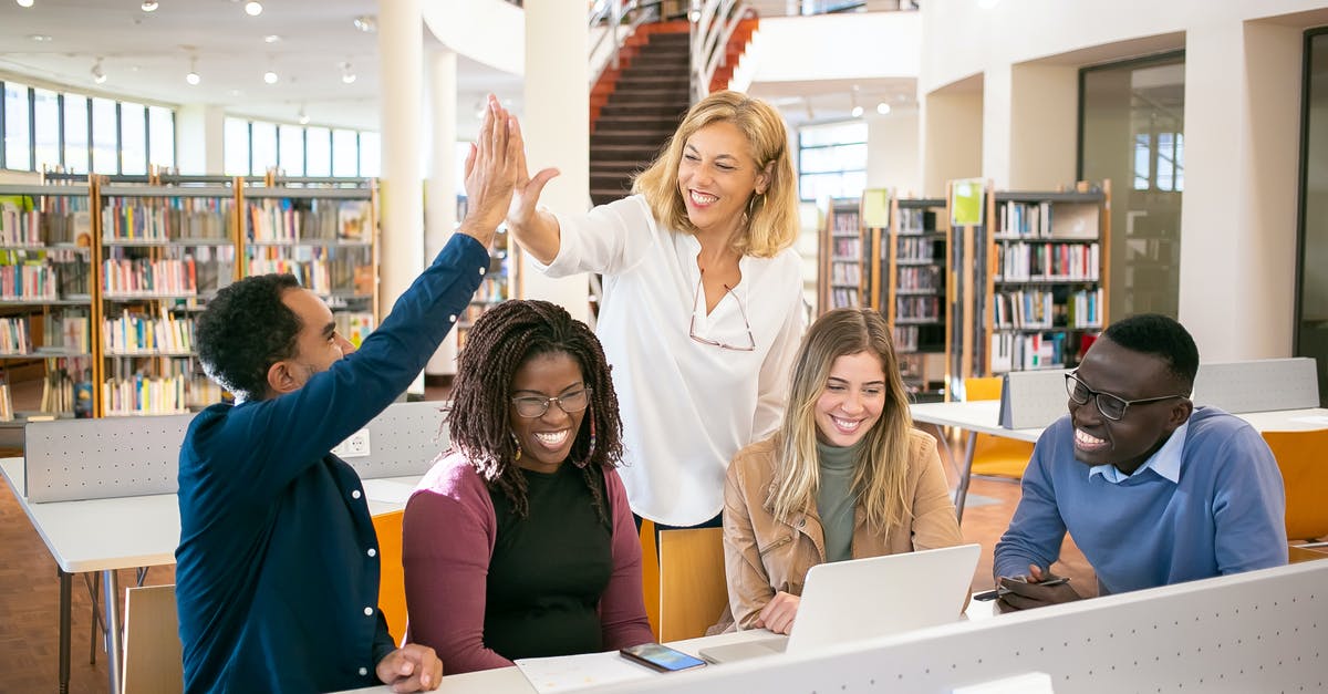 Stronger bread, how could I achieve that? - Cheerful multiethnic students having high five with teacher