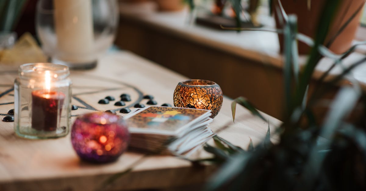 Stuffed peppers that don't burn on to the pot - Luminous candles in holders near tarot cards on table with oracle symbol at home