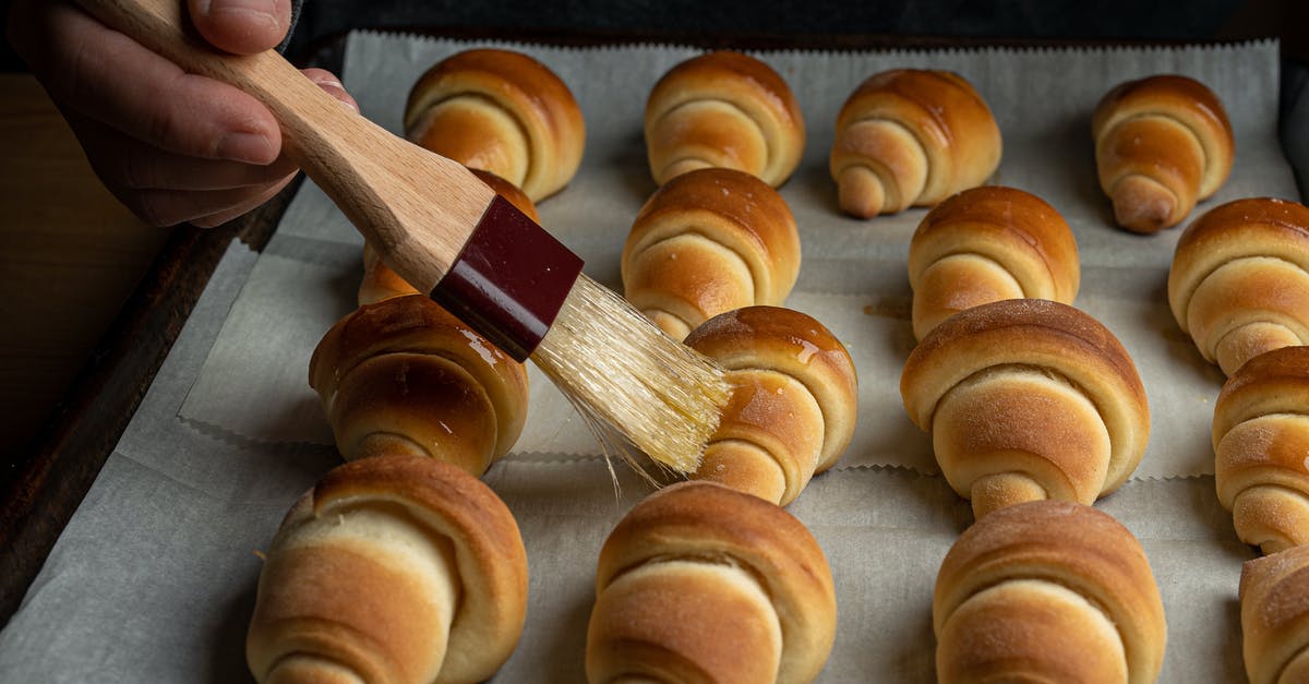 Substituting oil in baking? - A Person Applying Oil on Croissants with a Wooden Brush