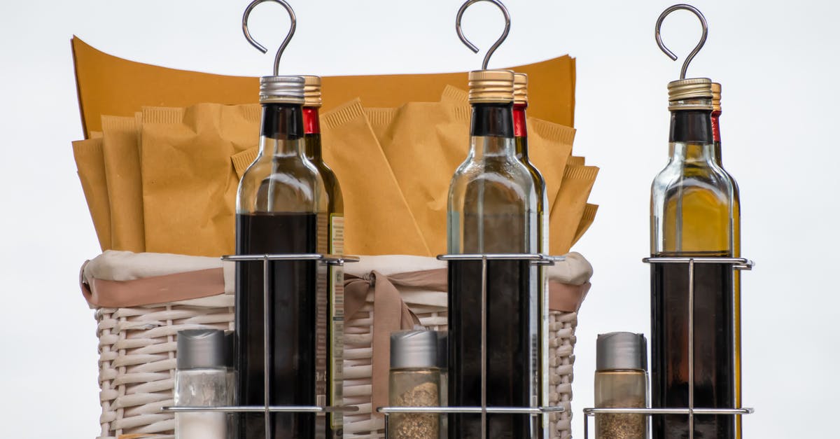 Substituting white wine vinegar with red wine vinegar - Clear Glass Bottles on Stainless Steel Rack