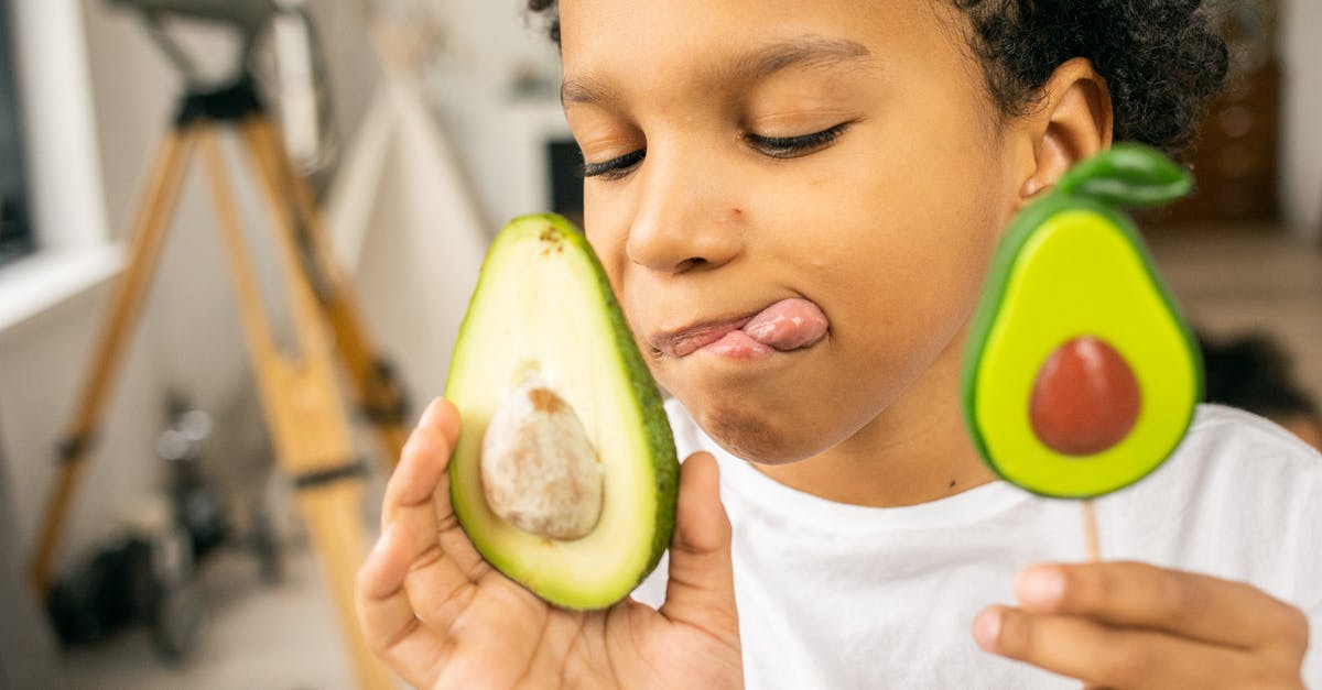 Sugar content of food - Positive black boy with lollipop and avocado