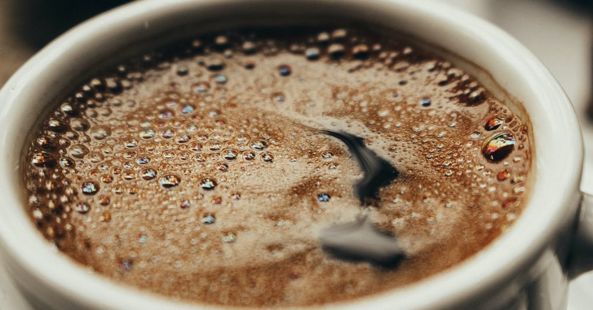 Sugar forming tiny bubbles in microwaved coffee? - Close-Up Photo of Black Coffee