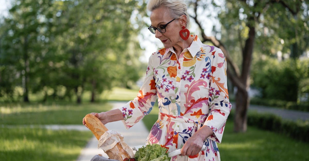 Suggestions for Brie + Bread + Preserves - Woman in White Red and Yellow Floral Dress Holding Brown Wicker Basket