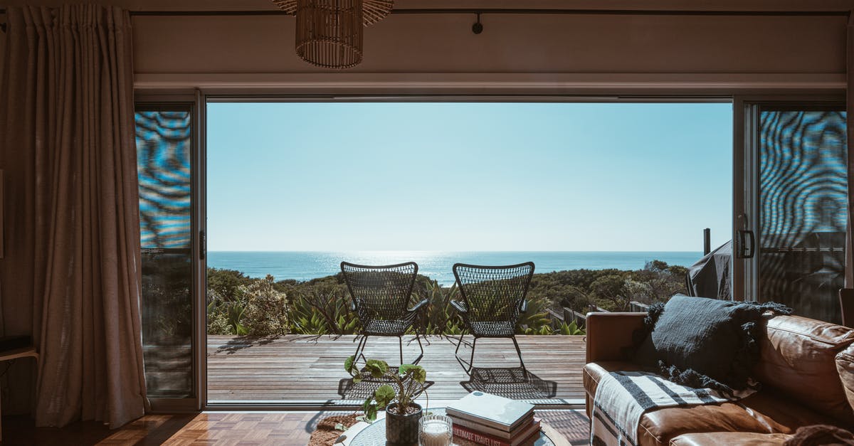 Super soft fried shrimp in a light batter - Interior design of luxurious apartment with large balcony doors and wooden terrace having picturesque view on green forested seashore and calm blue sea