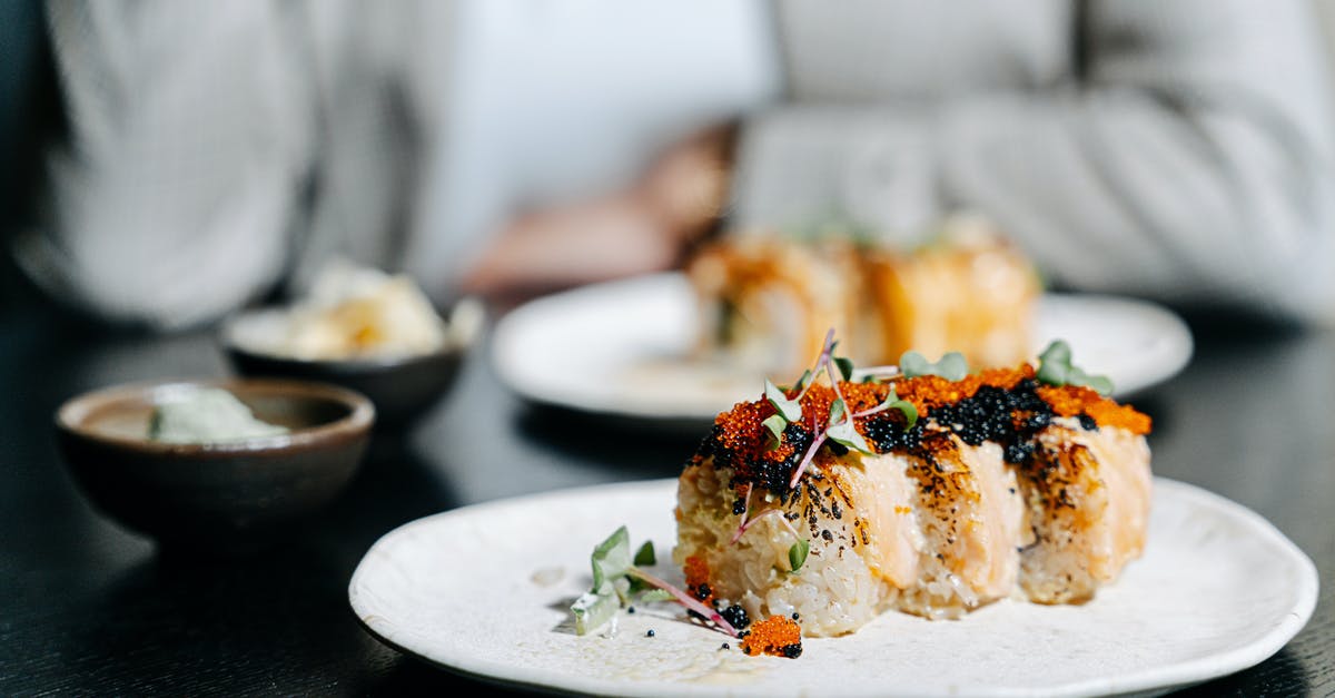 Sushi rolls opening up - Garnished Sushi Rolls on a Ceramic Plate
