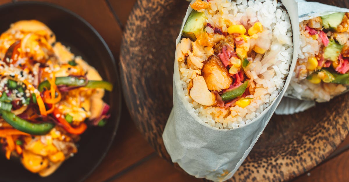 Sushi using brown rice - Vegetable Salad on Black Ceramic Bowl