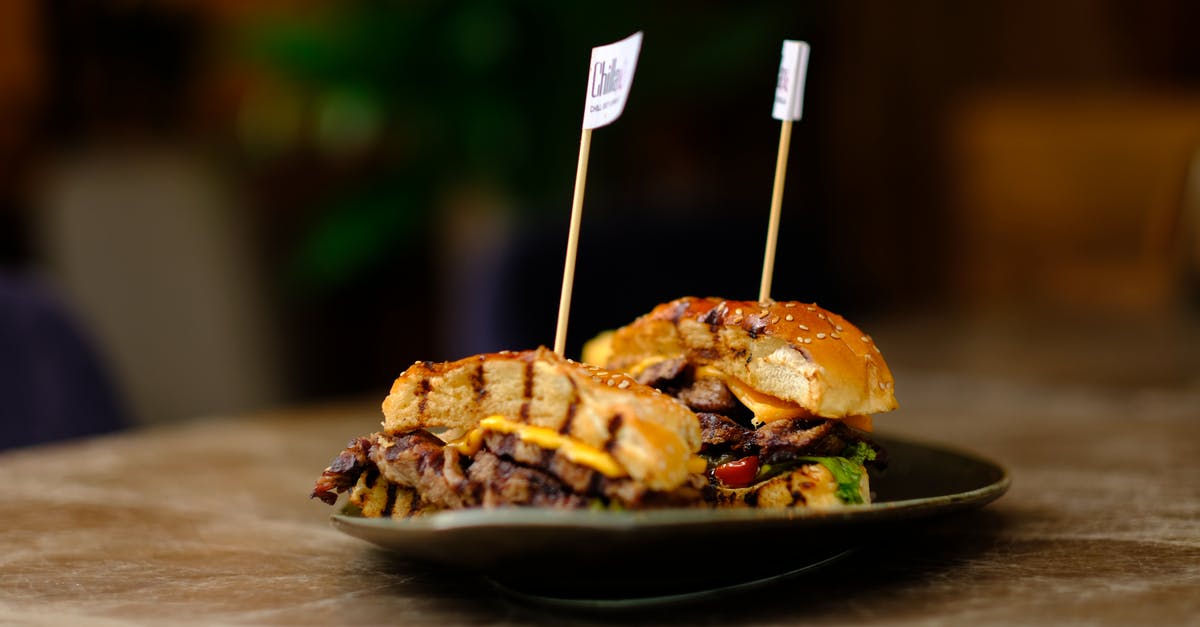 Tasty vs Mild vs Mature Cheddar Cheese - Burger on Black Ceramic Plate