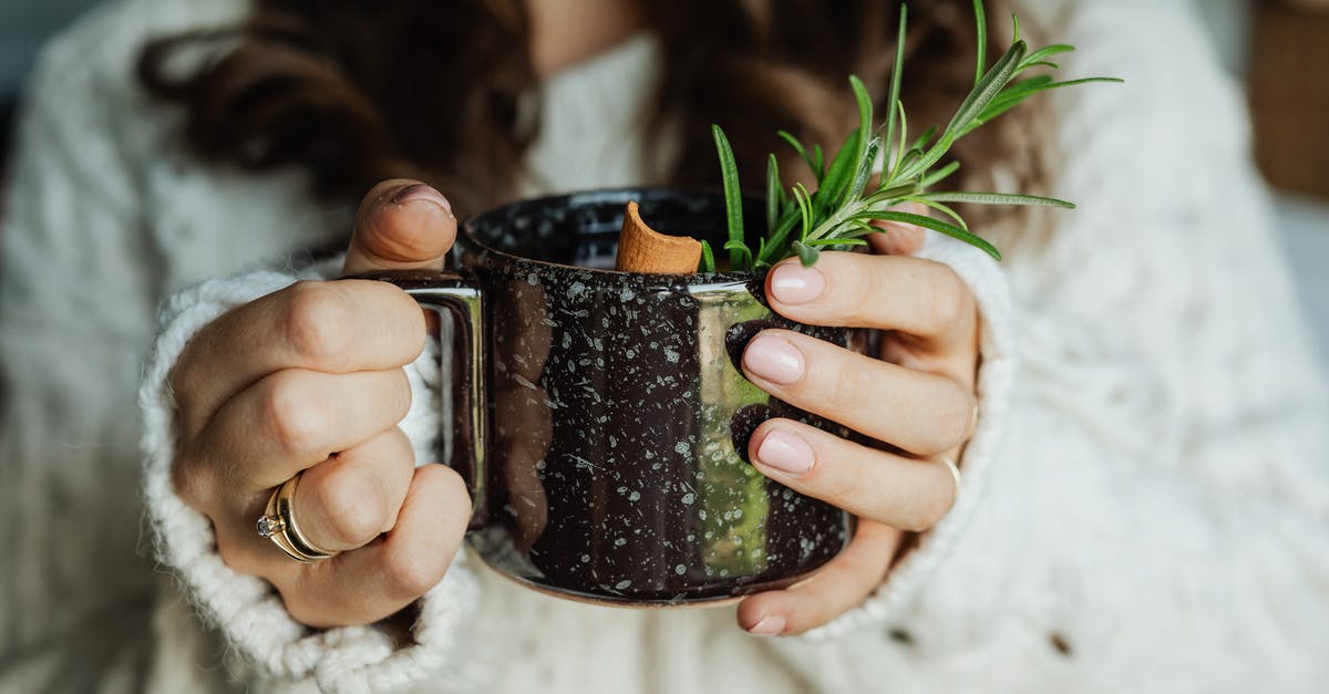 Tea cup residue - Person Holding Black and Brown Ceramic Mug