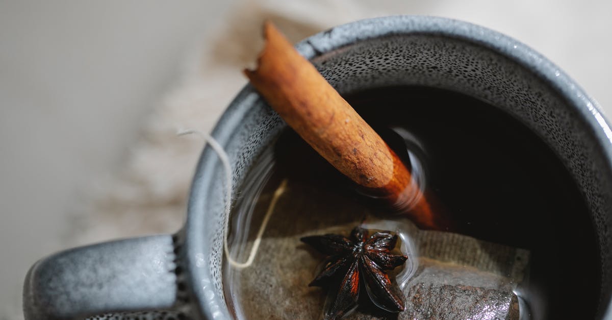 Tea-flavored concentration from a teabag - Cup of tea with anise and cinnamon