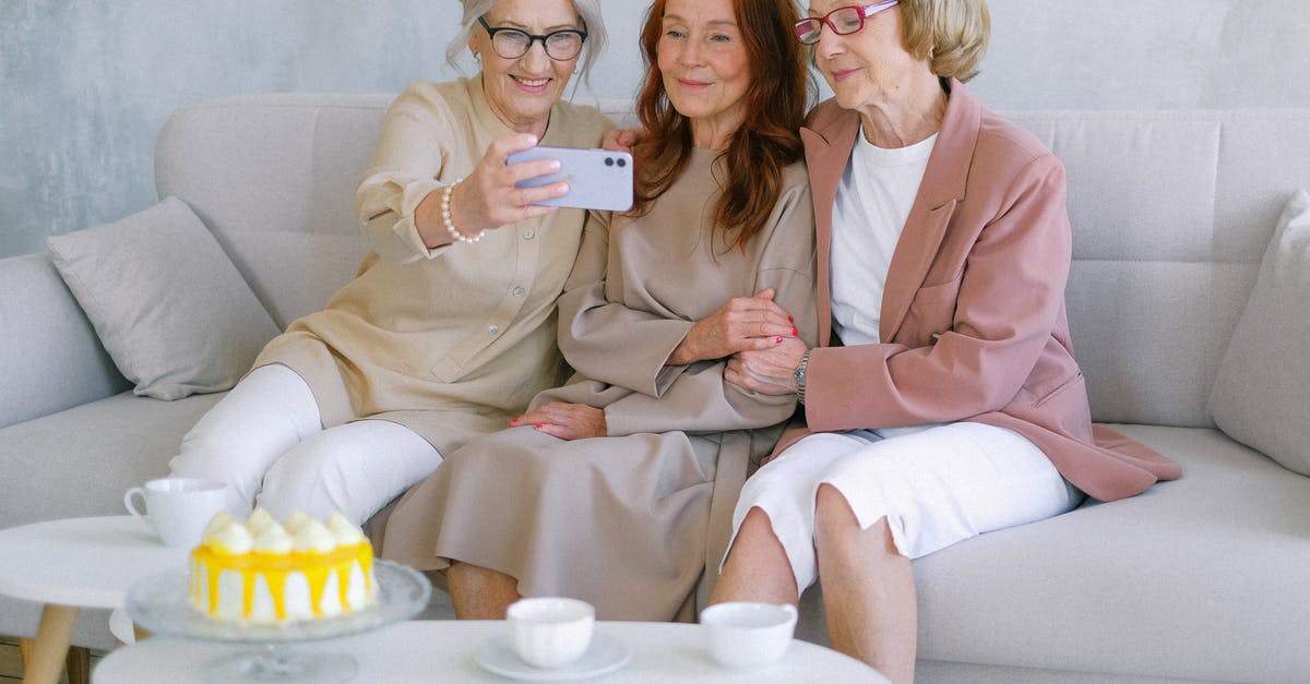 Temp and time for using half the recipe of cake - Happy senior women taking selfie on mobile phone at table with sweet delicious cake and cups