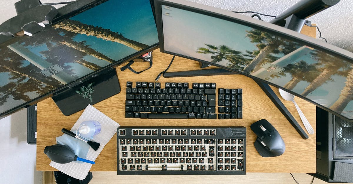 Temperature controlled work surface? - From above of desktop with multi monitors and keyboard with remove keycaps for cleaning