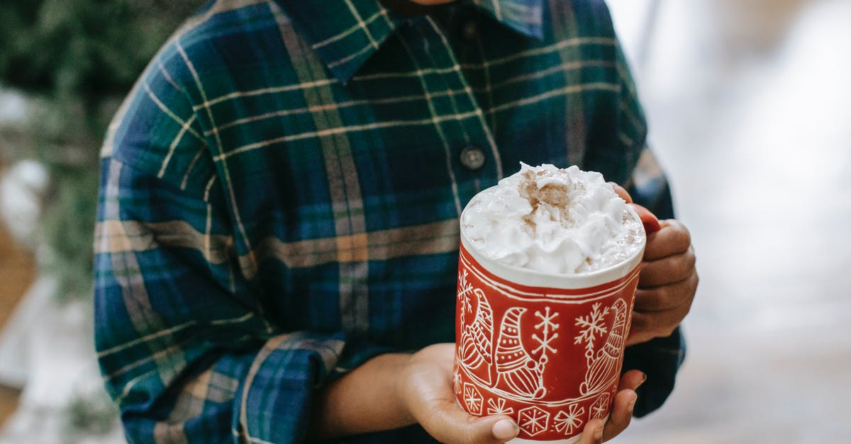 Temperature of Heavy whipping cream in NY cheesecake? - Black child holding mug of hot drink with foam