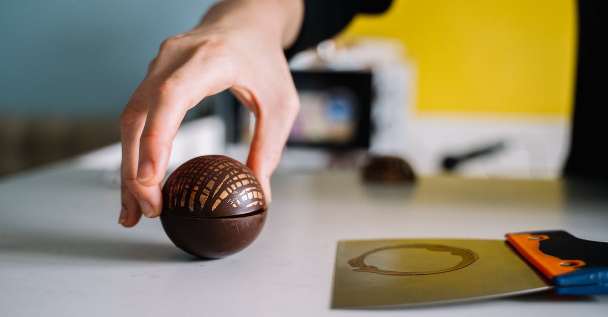 Tempered chocolate spheres in advance? - Person Holding Brown Chocolate Sphere