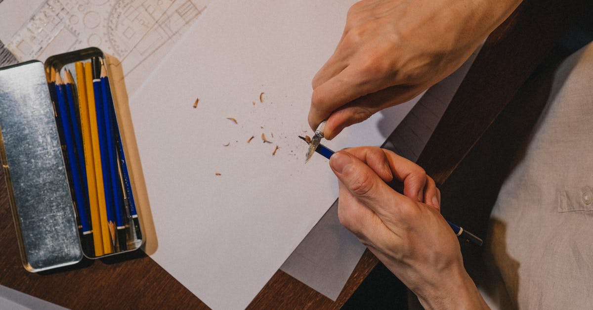 Tempering chocolated fail! - Close up on mans hands tempering pencil over drawing