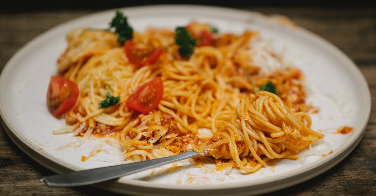 Teryaki sauce becomes viscous after boiled - Tasty pasta Bolognese and fork served on table