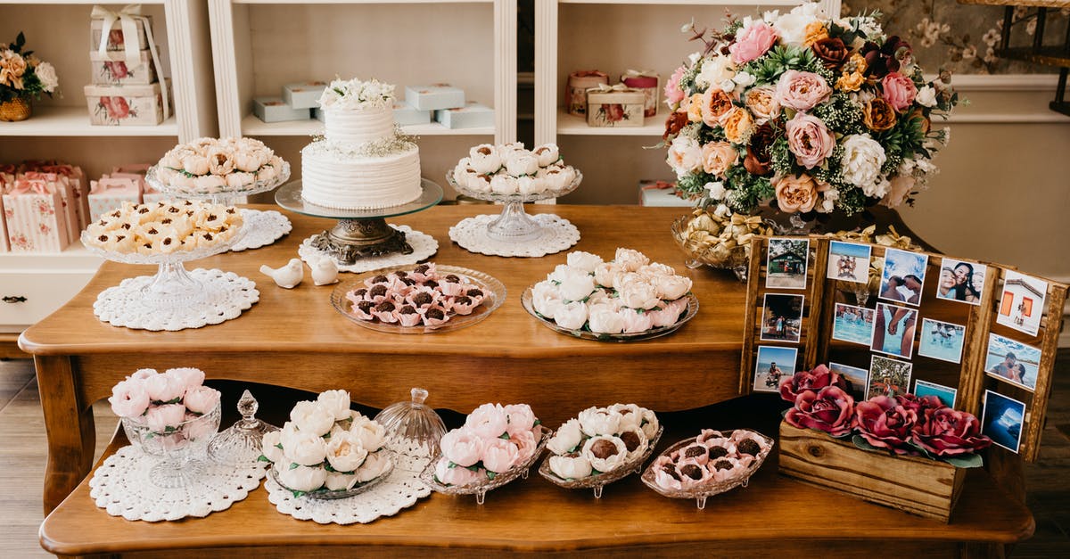 Test if whitish chocolate has bloom or is spoiled - Assorted sweets on table with blooming flowers on wedding day