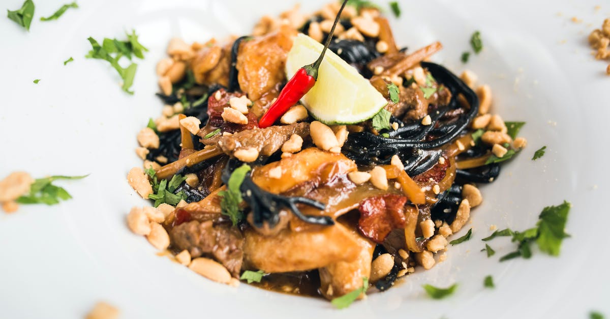 Thai noodle dish with peanuts - Delicious Asian pasta with meat slices and peanuts