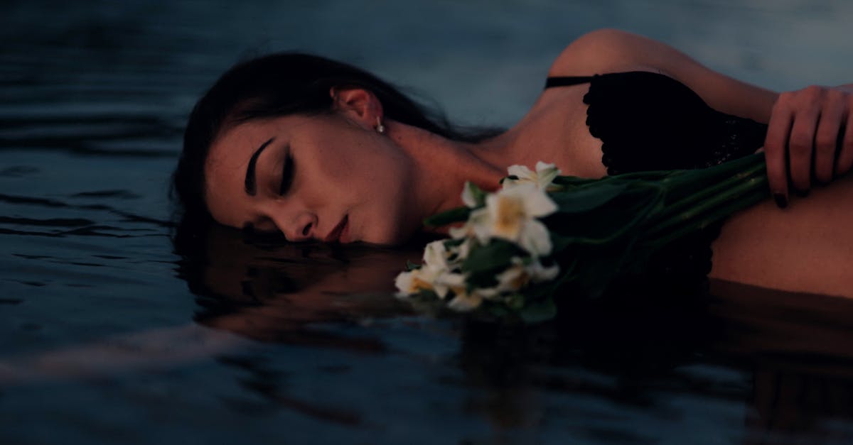 Thawed shrimp floating vs. sinking - Woman in Black Brassiere Lying on Water With White Flowers