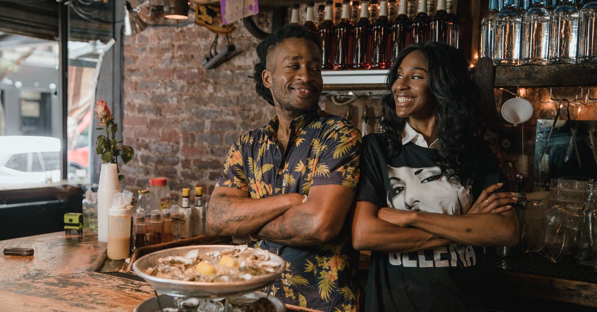 Thawing frozen seafood mix is a lot of work - Man and Woman at Bar Counter