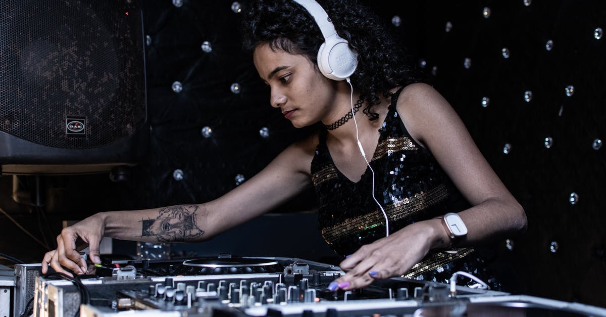 The art of Sushi: using wasabi to kill parasites - Focused ethnic female DJ playing music at nightclub