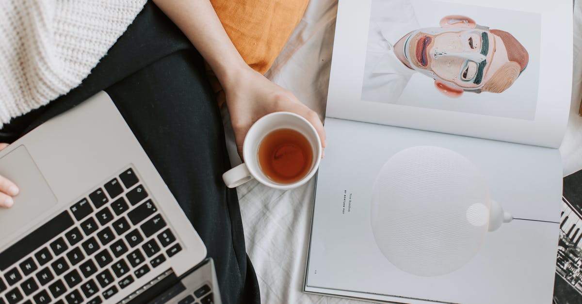 The art of Sushi: using wasabi to kill parasites - Faceless woman with cup of tea and laptop and book on bed