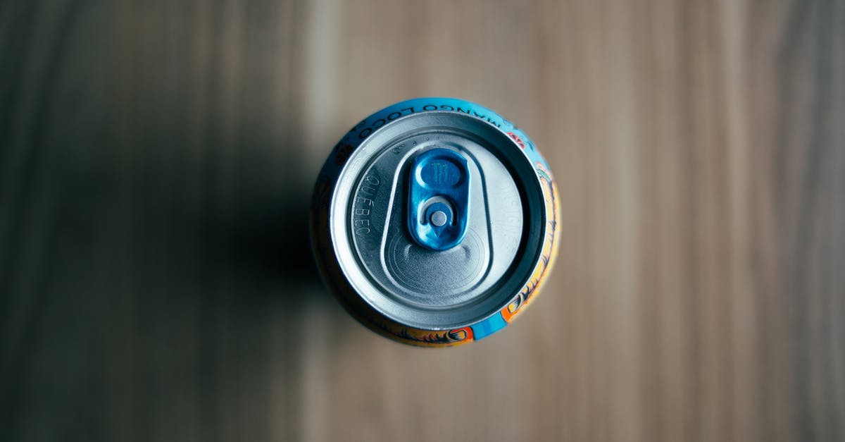 The mystery of heating up canned beans- What the tin says - A Can of Drink over a Wooden Table