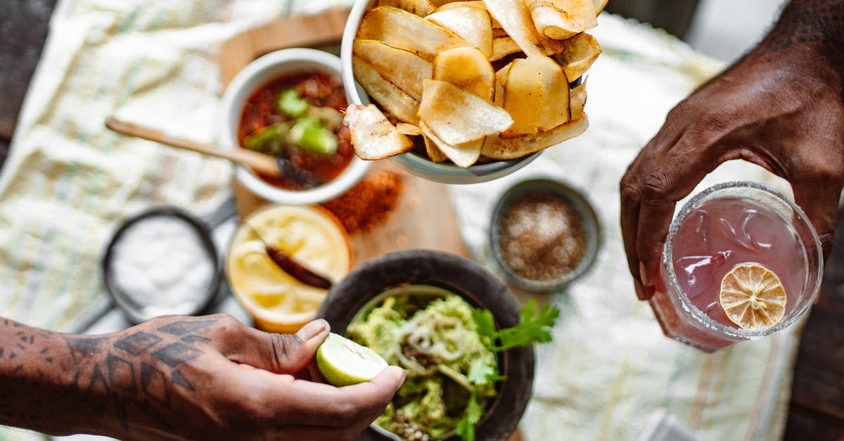 The three Cs - spices with chicken - Three Unrecognizable Hands Holding Chips Lime and Cold Fruit Drink