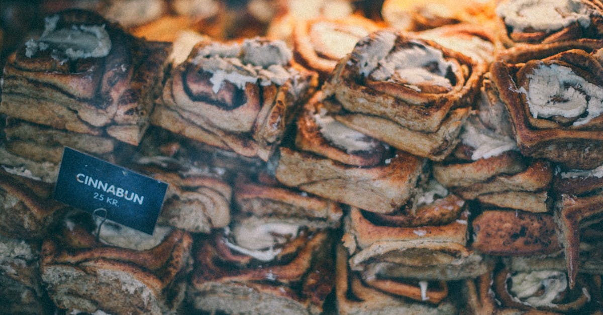 Thickness of ready-to-roll icing - Through glass of sweet delicious buns with sugar powder and cream placed on counter in shop