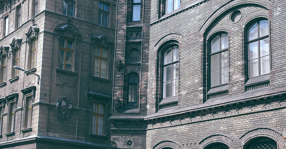 Three day old pancake batter with grey spots - Aged multistory masonry building facades with gray front walls in city on sunny day