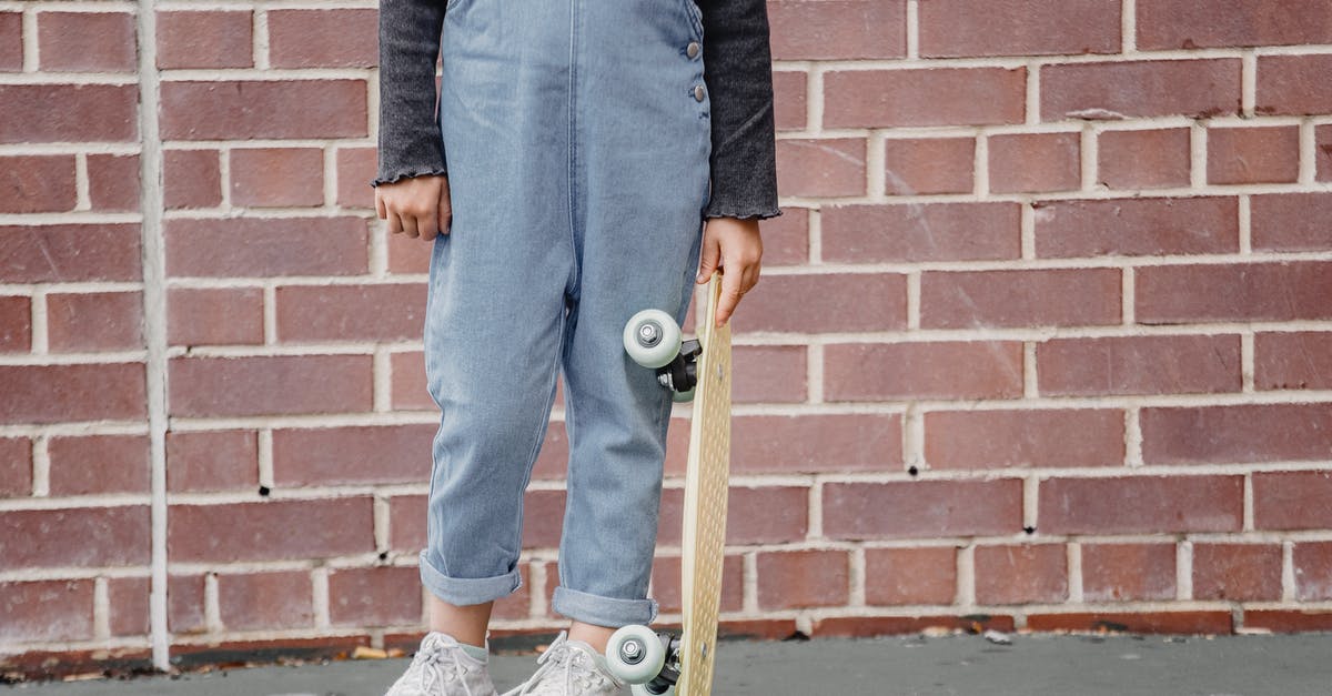 Time&Temperature vs energy needed for molecules structure's changes - Crop kid with skateboard near brick building