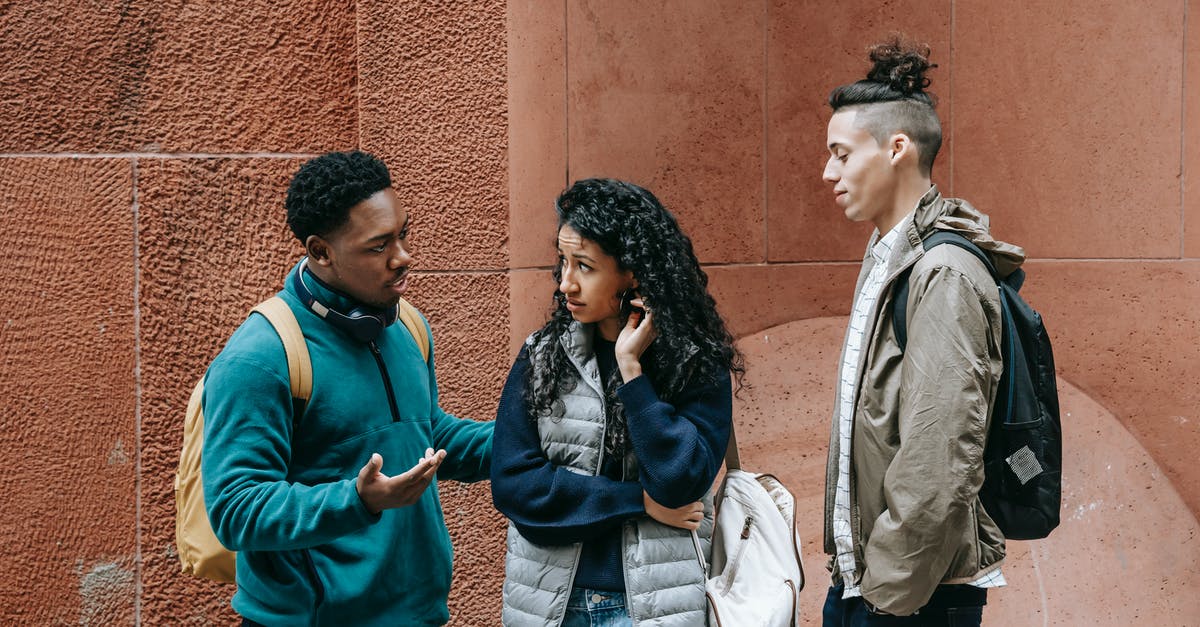 Timing problem! [duplicate] - Diverse teens chatting on street after studies