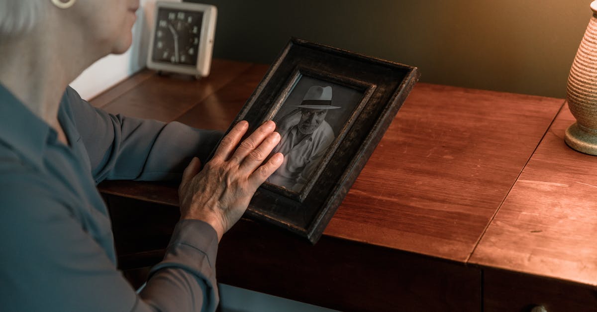 Tips for remembering recipes - Person in Blue Long Sleeve Shirt Holding Black Wooden Picture Frame